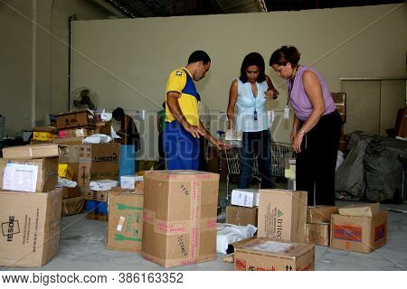 Eunapolis, Bahia / Brazil - April 1, 2008: Correios Employees Sort Orders For Delivery In The City O