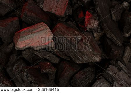 Smoldering Charcoal Background. Close-up Of Actively Smoldering Embers With Ash.