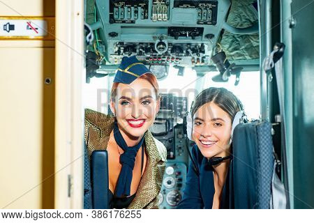 Beautiful Woman Pilot Wearing Uniform. Happy And Successful Flight. Looking At Camera In Plane. Girl