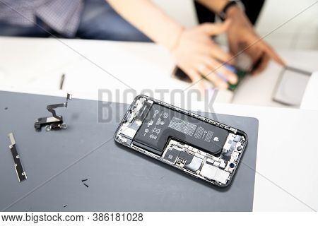 Russia - July 27, 2020: Repair Iphone Apple Broken Phone Screen And Replace Used Rechargeable Batter