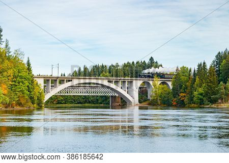 Kouvola, Finland - 18 September 2020: Autumn Landscape Of Bridge With Moving Old Steam Passenger Tra