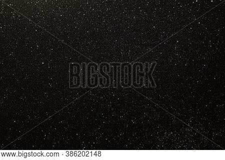 Black Texture With Micro-relief And Glitter Similar To The Night Sky With Stars