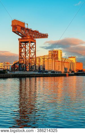 GLASGOW, UK - FEB 26, 2020: The Finnieston Crane or Stobcross Crane stand at waterfront of city center in Scotland, United Kingdom as the symbol of engineering heritage