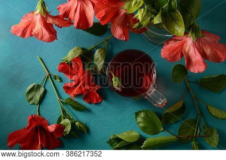 Hibiscus Tea In A Glass Transparent Teapot, And Blossom Flower