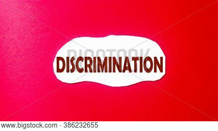 Discrimination Written On A Scrap Of Paper And A Red Background. Abolition Of Discrimination Concept