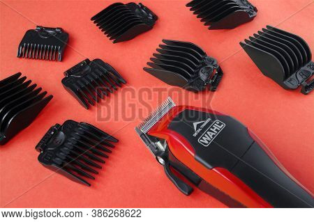 Kharkov, Ukraine - July 2, 2020 : Hairdressers Tool. Hair Clipper Wahl Close-up On A Red Background 
