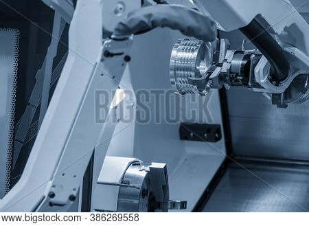 The Hi-technology Cnc Lathe Machine Operation With Gripping Robotic System. The Cobot  Operation Con