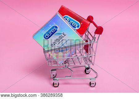 Kyiv, Ukraine - 15 July 2020: Durex Condoms In A Shopping Trolley On The Pink Background. Durex Elit