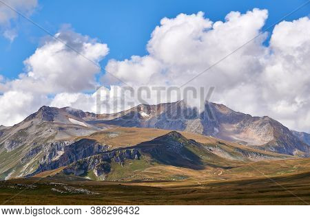 Beautiful Mountain Treeless Autumn Landscape With Clouds And Blue Sky