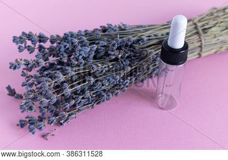 Bouquet Of Dried Lavender Flowers On A Pink Background. Glass Ampoules On Which Chloride 5ml Is Writ