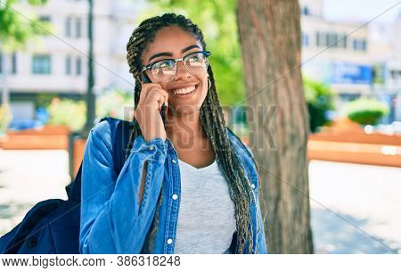 Young african american student woman smiling happy speaking on smartphone at the university campus