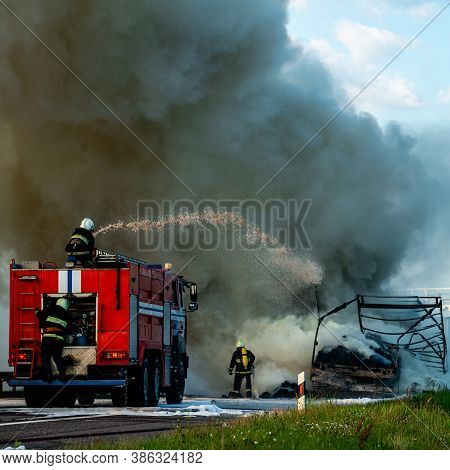 Firefighters Put Out The Fire With Foam In The Car, Fire Engine Extinguishes A Fire On The Road