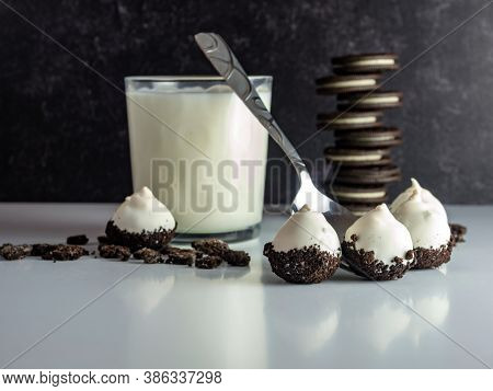 Cookies And Cream Cake Balls With A Glass Of Milk, Silver Spoon And A Pile Of Cookies And Cookie Cru
