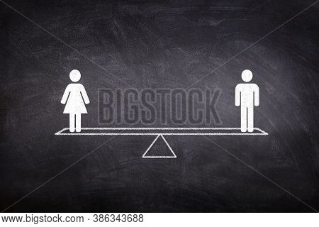 Gender Equality Concept : Male And Female Figure Icon Symbols Balancing On Seesaw Or Balance Scales 
