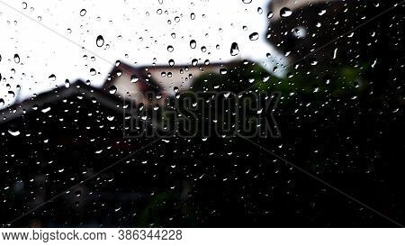 Rain Drop On The Glass Wall Tranparency And See The City Behind In Blur