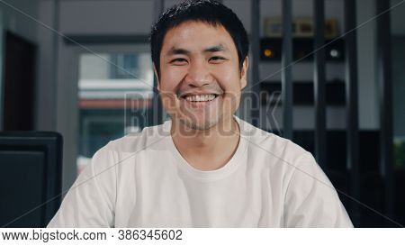Portrait Asian Chinese Man Feeling Happy Funny At Home. Young Male Relax Toothy Smile Looking To Cam