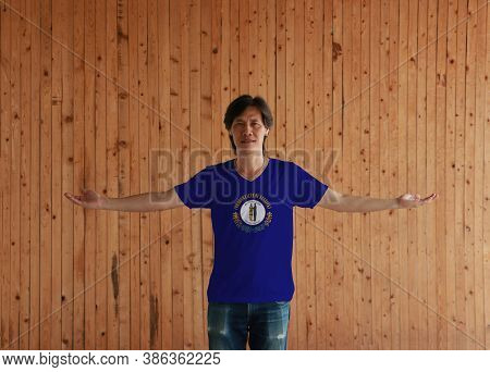 Man Wearing Kentucky Flag Shirt And Standing With Arms Wide Open On The Wooden Wall Background, Kent