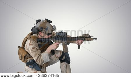 Paratrooper In Uniform Shooting From Sitting Position On Gradien