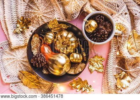 Autumn Frame With Shiny Golden Decorative Pumpkins And Leaves In Bowl On A Pnk Bacround. Flat Lay, T