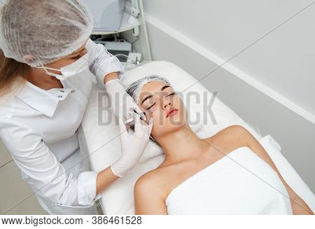 Woman Getting Cosmetic. Injection. Beauty Injections And Cosmetology.  Young Woman In Beauty Salon S