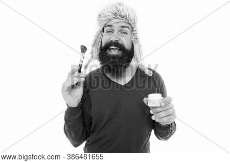 Freak Visagiste. Applying Makeup Face Tone. Powder Cosmetics. Man Bearded Stylist Wear Hat Hold Brus