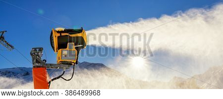 Operating Artificial Snow Cannon Near Piste Making Snowy Powder.ski Lift Ropeway On Hilghland Alpine