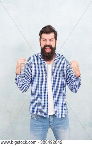 All It Takes Is All Youve Got. Happy Hipster Celebrate Victory Blue Background. Bearded Man Keep Arm