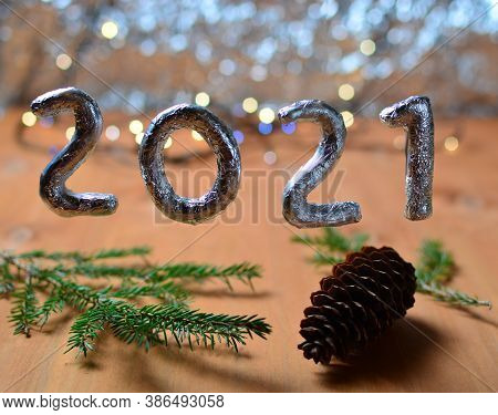 Numbers 2021 Set Against Blurry Silver Lights. Concept Of The Coming New Year
