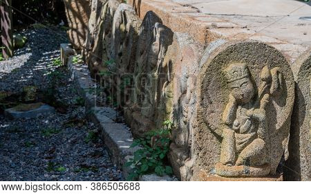 Geumsan, South Korea; September 12, 2020: Rock Carved Monks On Brick Base Of Structure At Dongguksa 