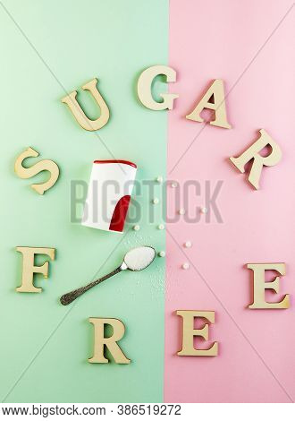 Sugar Substitute Pills And Natural Sweetener In Powder On A Green-pink Background And Sugar Free Ins