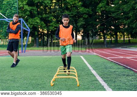 Childrens Football Players During Team Training Before An Important Match. Exercises For The Youth F