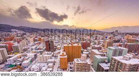 Sapporo, Japan winter skyline view towards the mountain at dusk.
