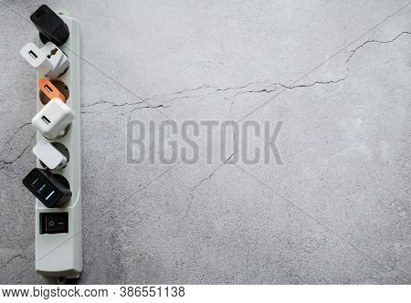 Running Modern Extension Power Strip With Many Different Usb Dc Output Ports. Cracked Concrete Backg