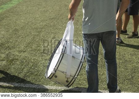 Big Drum At A Football Match. A Man With A Braban To Support Football Players. White Percussion Musi