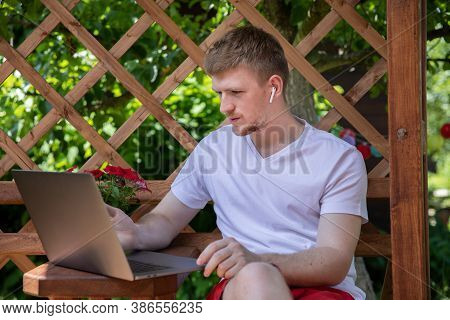 Confident Businessman In Casual Clothes Sits Outdoors On Teracce Working Remotely, Male Freelancer I