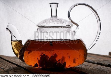 Teapot With Brewed Hot Tea On A Wooden, Cozy Background