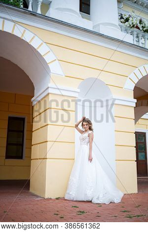 Portrait Of A Beautiful Young Girl In The Brides Wedding Day, Dressed In A White Wedding Dress On A 