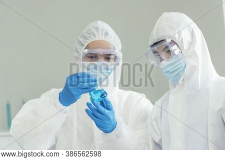 Two Asian Scientist Team Reserch Chemistry Science Tube Experiment Biotech Antibody Sample In Labora