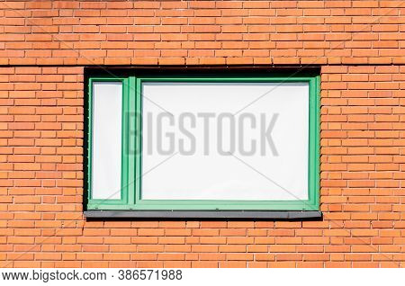 The Window Is Tightly Covered With A Roll-up Curtain