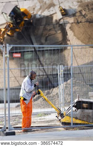 Rotterdam, Netherlands - September 11, 2020: Construction Worker With A Wacker Smoking A Cigar   And