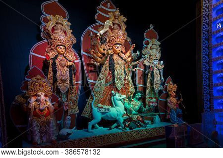 Decorated Durga Puja Pandal With Goddess Durga Family Idol, Durga Puja Festival At Night. Shot Under