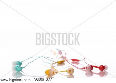 Green Yellow And Red Earphones Isolated On White Background. Playlist, Podcast, Entertainment, Relax