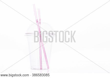Clear Empty Plastic Cup With Dome Lid And Two Pink Plastic Straws For Milkshake Isolated On White Ba