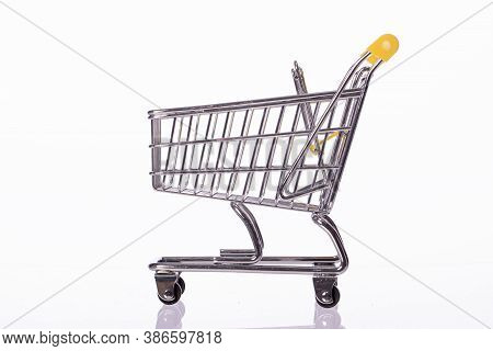 Small Empty Shopping Cart Trolley Isolated On White Background. Department Store, Supermarket, E-com