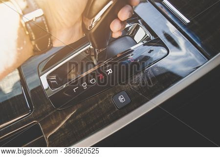 The Driver's Hand Moved The Gear Selector To The Reverse (r) Mode Of The Automatic Transmission In T