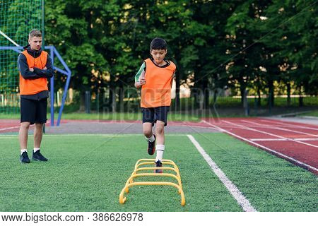 Childrens Football Players During Team Training Before An Important Match. Exercises For The Youth F