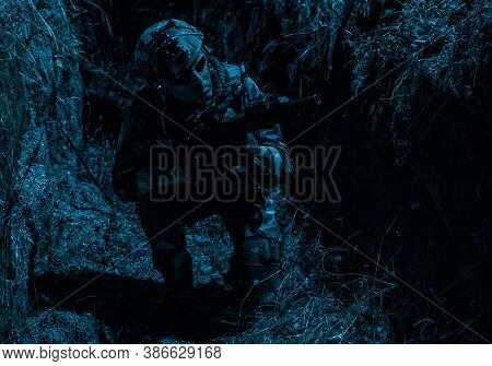 Army Soldier, Special Forces Infantryman In Combat Uniform And Helmet, Armed Assault Rifle, Sneaking