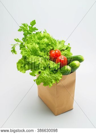 Various Ingredients For Vegetable Salad. Freshly Harvested Greensand Vegetables In A Paper Craft Bag