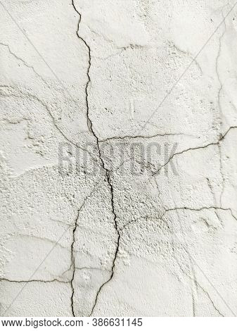 Grunge Background With A Cracked White Stone Wall. The Texture Of The Stone