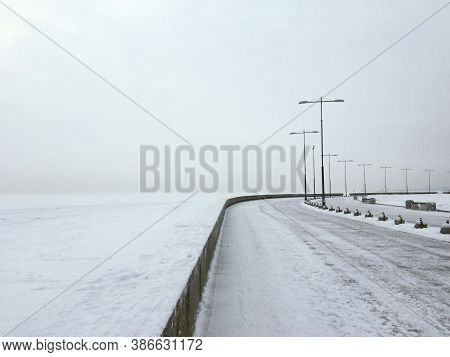 Urban Winter Landscape In White Tones With An Empty Embankment